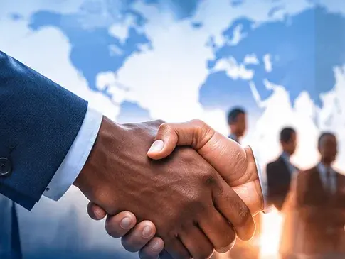 Two people shaking hands in a business setting.